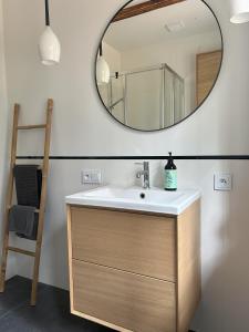 a bathroom with a sink and a mirror at Dom w lesie in Dzbądzek +8 photos