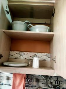 a cupboard with some bowls and plates in it at Rembeka furnished apartments in Naivasha