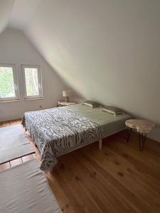 a bedroom with a large bed in a attic at Dom w lesie in Dzbądzek