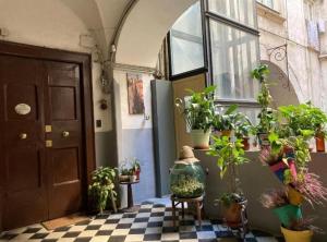 a room with a bunch of potted plants and a door at Casa Baglioni in Naples