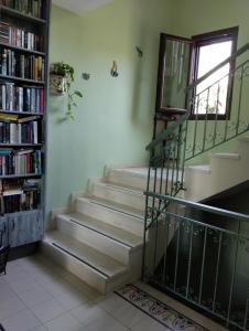 a staircase in a room with a window and a book shelf at Harmony resort in Parga