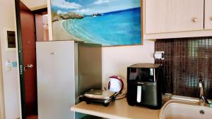 a kitchen counter with a coffee maker on a counter top at Yasoo Holiday Apartments in Olympiada +25 photos
