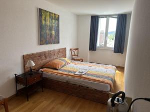 a small bedroom with a bed and a window at Hôtel de Ville in Les Verrières
