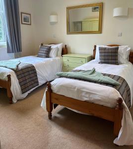 En eller flere senge i et værelse på Station House Holiday Cottages, Exclusively For Grown Ups, Thornton Dale