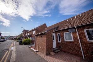 a brick house on the side of a street at The Bradan - Troon - Coorie Doon Stays in Troon
