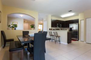a dining room and kitchen with a table and chairs at Miami VACATION House Cribkeys in Homestead