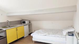 a small room with a bed and a sink at Studio Pour Une deux Personnes in La Courneuve +4 photos