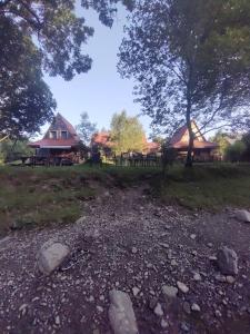 a field with some houses and trees and rocks at Domek MAGELLAN BIS Cisna 11 in Cisna