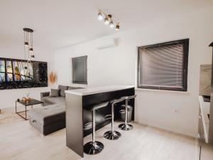 a living room with a bar and a couch at Villa Eden Bihać in Bihać +14 photos