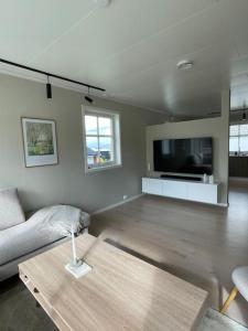 a living room with a couch and a coffee table at House with 5 bedrooms, 2 bathrooms, available for ONSS in Stavanger