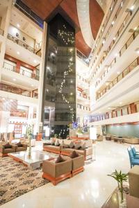 a lobby with couches and tables in a building at Clarion Bella Casa at Airport in Jaipur