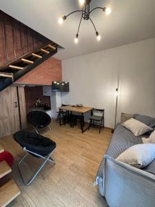 a room with two beds and a dining room with a table at Domus kobuleti in Kobuleti