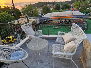 a balcony with chairs and a table and a ride at Eleni Siviri in Siviri +18 photos