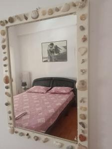 a mirror reflecting a bed in a bedroom at Classical beauty near Acropolis! in Athens +41 photos