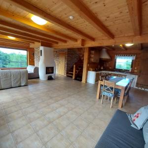 a large living room with a table and a couch at DUSZNICa 35 in Sejny +25 photos