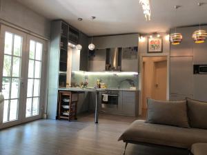 a living room with a couch and a kitchen at Pines House in Draç