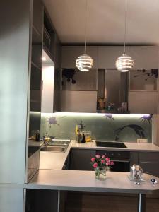a kitchen with a counter with flowers on it at Pines House in Durrës +25 photos