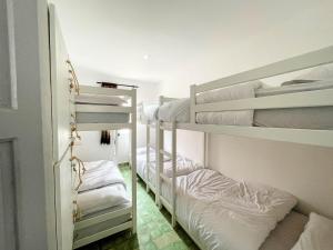 a couple of bunk beds in a room at Taouarguit Guest House in Imsouane
