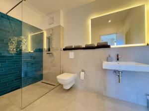 a bathroom with a toilet and a sink and a shower at Erholen am See in Lychen +28 photos