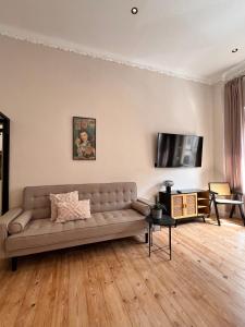 a living room with a couch and a flat screen tv at Modern Stay I Cosy & Central Apartments in Koblenz +78 photos