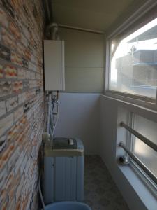 a corner of a room with a brick wall at Retro Naseong House in Jeonju +69 photos