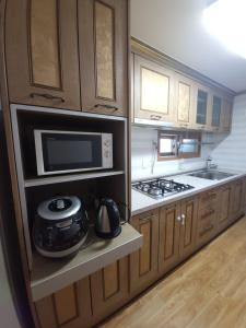 a kitchen with a microwave oven and a stove at Retro Naseong House in Jeonju