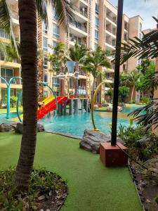 a pool at a resort with a water slide at Atlantis pattaya by ramita in Jomtien Beach