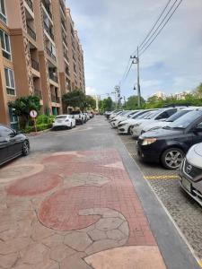a parking lot with cars parked in a parking lot at Atlantis pattaya by ramita in Jomtien Beach