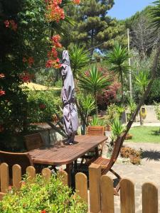 a statue sitting on a wooden table in a garden at Il Pettirosso in Acciaroli