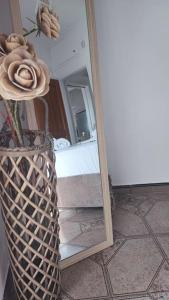 a vase with a flower in front of a mirror at Althea Dream Summer House in Marmari +75 photos