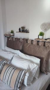 a couch with pillows on it in a room at Althea Dream Summer House in Marmari