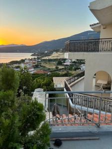 a balcony of a building with a sunset in the background at Althea Dream Summer House in Marmari