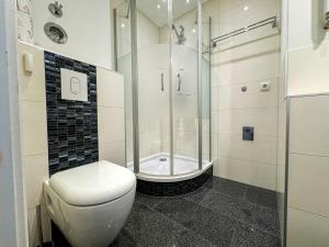 a bathroom with a shower and a toilet in it at Business Apartment Altstadt in Bremen +85 photos