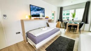 a bedroom with a bed and a table in it at Business Apartment Altstadt in Bremen