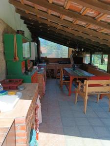 a kitchen with a table and a dining room at Etno Kuća - Rakić in Svrljig