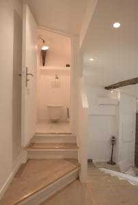 a hallway with stairs leading up to a bathroom at VALBONNE Maison cœur de village in Valbonne +58 photos