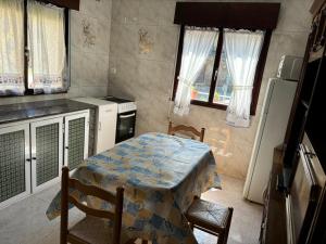 a kitchen with a table and chairs in a kitchen at San Salvador 11 in La Plaza