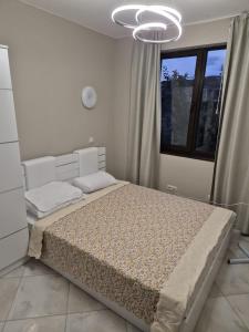 a bedroom with a bed and a chandelier at Dream Villa in Imperial Heights Villas in Sunny Beach