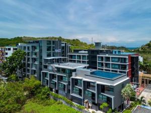 an aerial view of a building with a swimming pool at Taya NaiHarn, Scenic View, Modern Studio, Relife Windy in Rawai Beach