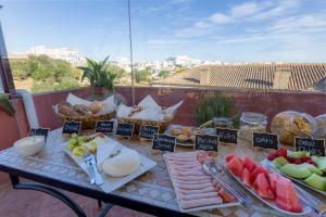 a table topped with lots of different types of food at Casa da Moura in Lagos