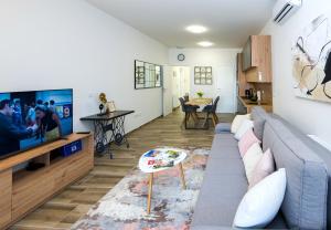 a living room with a couch and a tv at Complex nine in Osijek