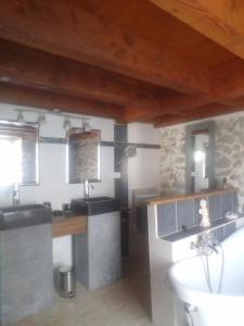 a bathroom with two sinks and a white tub at Les maisons d'Ustou. in Ustou +13 photos