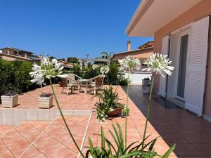 a patio with white flowers on a house at Villa Serena in Monopoli