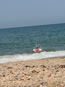 a person on a boogie board in the water at Comforts Plage in Fnidek