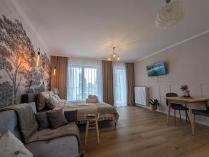 a living room with a couch and a table at Bagry Lake Apartment in Kraków