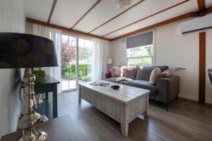 a living room with a couch and a coffee table at 08, ontdek het bosrijke Oisterwijk met het grootste terras van Nederland! in Oisterwijk