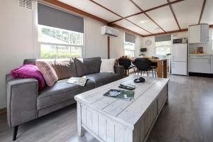 a living room with a couch and a coffee table at 08, ontdek het bosrijke Oisterwijk met het grootste terras van Nederland! in Oisterwijk