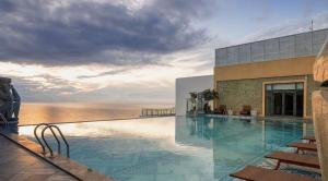a swimming pool with a view of the ocean at Apec SeaView Sun-Condotel Tuy Hoa in Tuy Hoa