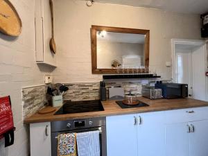 a kitchen with a counter top and a mirror at Kenton Mill Farm in Kenton