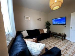 a living room with a blue couch and a table at Kenton Mill Farm in Kenton